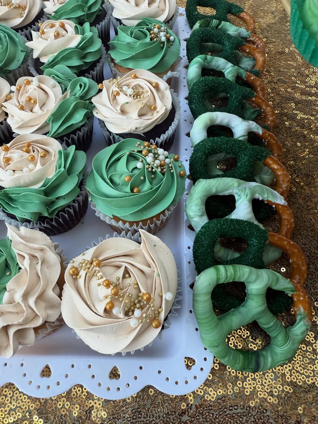 Green and cream rosette cupcakes with chocolate covered pretzels
